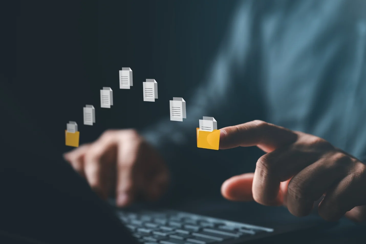 Businessperson using a laptop with floating folder and file transfer icons, symbolizing secure data sharing, cloud access, and digital file management.