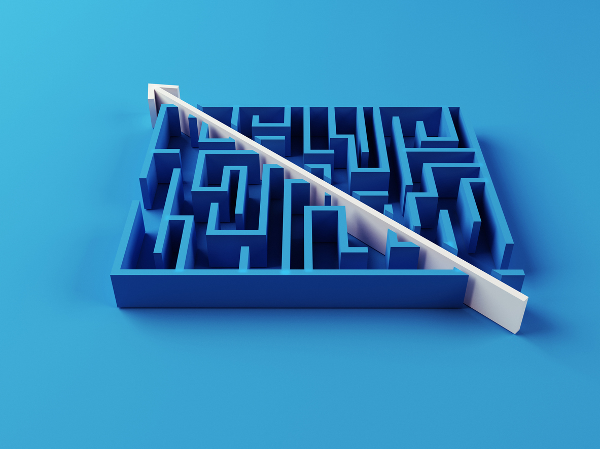 Top-down view of a maze with a clear path traced through it, representing a strategic and structured approach to solving complex business challenges like IT security.